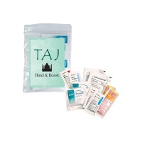 Sunscreen, lip moisturizer, hand sanitizer, lens cleaner wipes, lotion and burn gel in a bag with a laminated decal